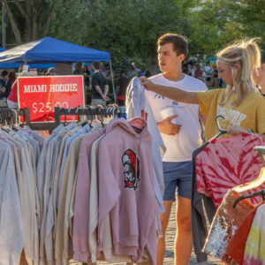 K3224 Red Brick Friday Uptown Oxford People shop for Miami University sweatshirts at an open air market.